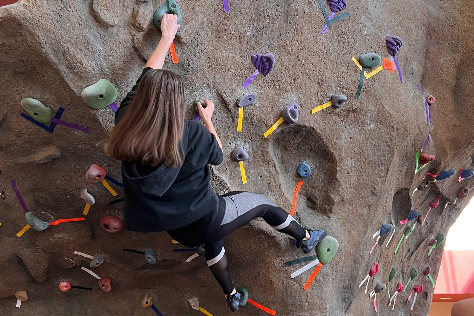 Teen climbing the bouldering climbing wall